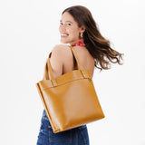Mango Medium Classic | Model wearing leather tote bag with riveted straps and exterior key loop