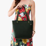 Evergreen Medium Zipper | Model wearing leather tote bag with riveted straps and exterior key loop