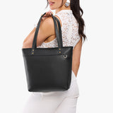 Pebbled--black Medium Zipper | Model wearing leather tote bag with riveted straps and exterior key loop
