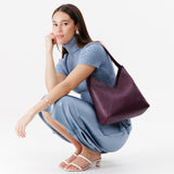 Plum Large | Model wearing mid-size shoulder bag with magnetic snap 