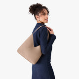 Stone Large | Model wearing mid-size shoulder bag with magnetic snap 