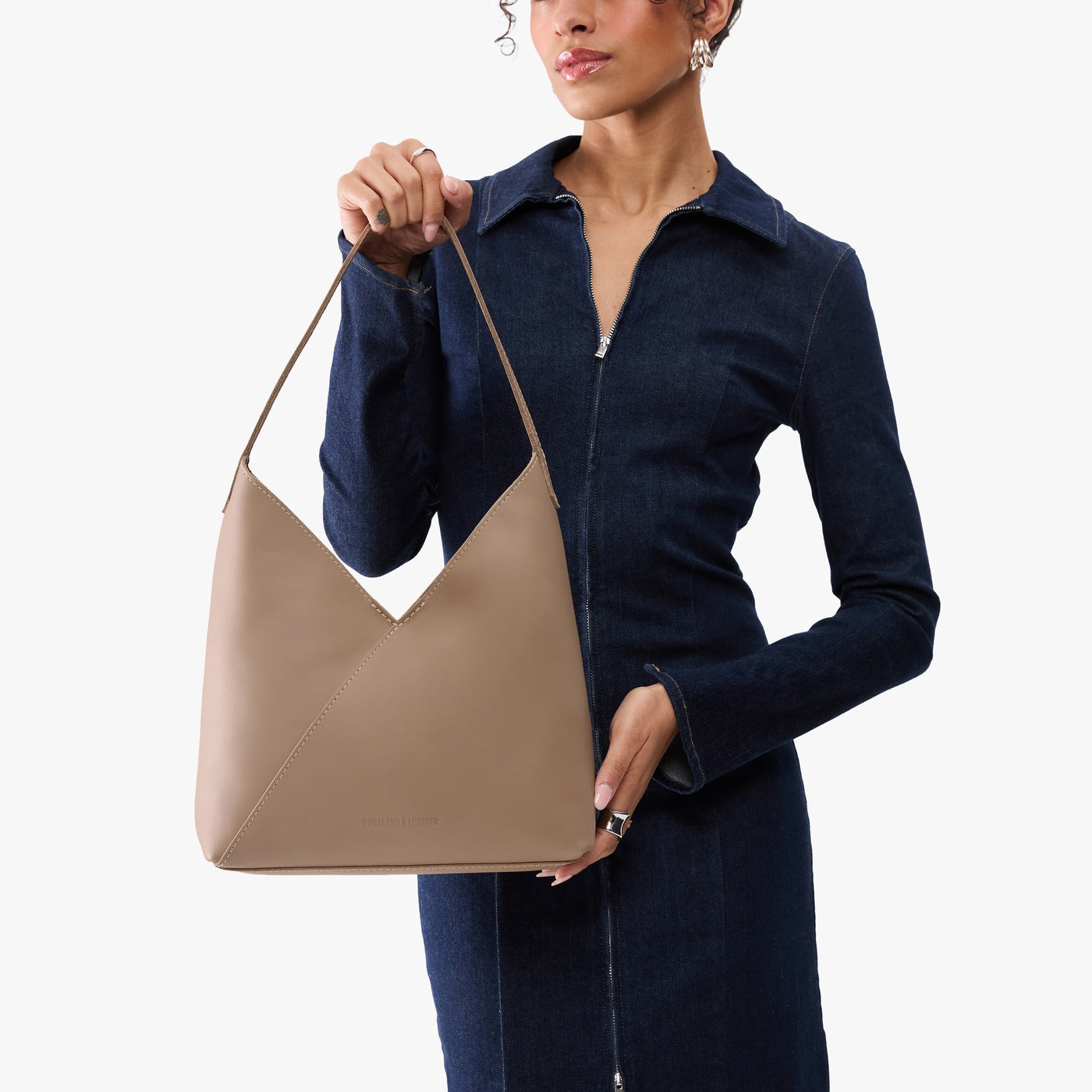 Stone*Large | Model wearing mid-size shoulder bag with magnetic snap 