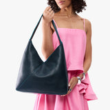 Boreal Oversized | Model wearing large shoulder bag with adjustable strap and magnetic snap closure