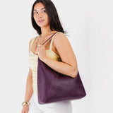 Plum Oversized | Model wearing large shoulder bag with magnetic snap closure