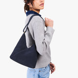 Alaska Blue Small | Model wearing petite shoulder bag with adjustable strap and magnetic snap closure