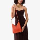 Koi Small | Model wearing petite shoulder bag with adjustable strap and magnetic snap closure