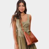 Sienna Small | Model wearing petite shoulder bag with adjustable strap and magnetic snap closure