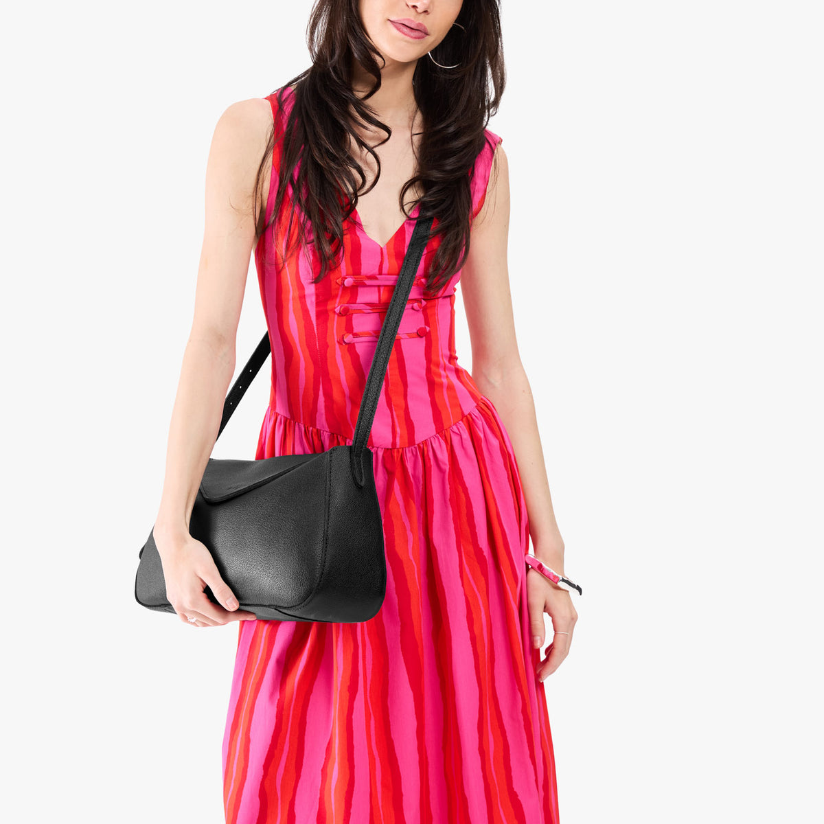 Pebbled--black*Medium | Model wearing a leather Crossbody with a flap and magnetic closure