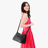 Pebbled--black Medium | Model wearing a leather Crossbody with a flap and magnetic closure