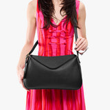 Pebbled--black Medium | Model wearing a leather Crossbody with a flap and magnetic closure