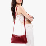 Chili Red Small | Model wearing a leather Crossbody with a flap and magnetic closure