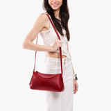 Chili Red Small | Model wearing a leather Crossbody with a flap and magnetic closure