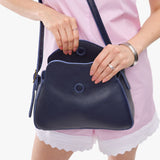 Cobalt Small | Model wearing a leather Crossbody with a flap and magnetic closure
