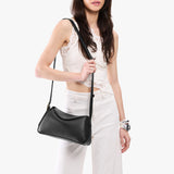 Pebbled--black Small | Model wearing a leather Crossbody with a flap and magnetic closure