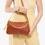 Sienna Small | Model wearing a leather Crossbody with a flap and magnetic closure