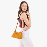 Sunshine Small | Model wearing a leather Crossbody with a flap and magnetic closure