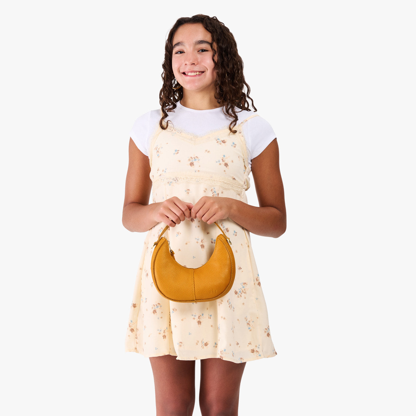 Sunshine | Model with a crescent shaped shoulder bag with zipper closure and gold accents