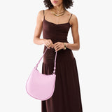 Pinkaboo Medium | Model holding round leather purse with adjustable shoulder strap