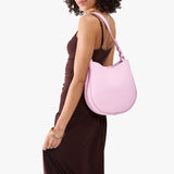 Pinkaboo Medium | Model carrying round leather purse with adjustable shoulder strap
