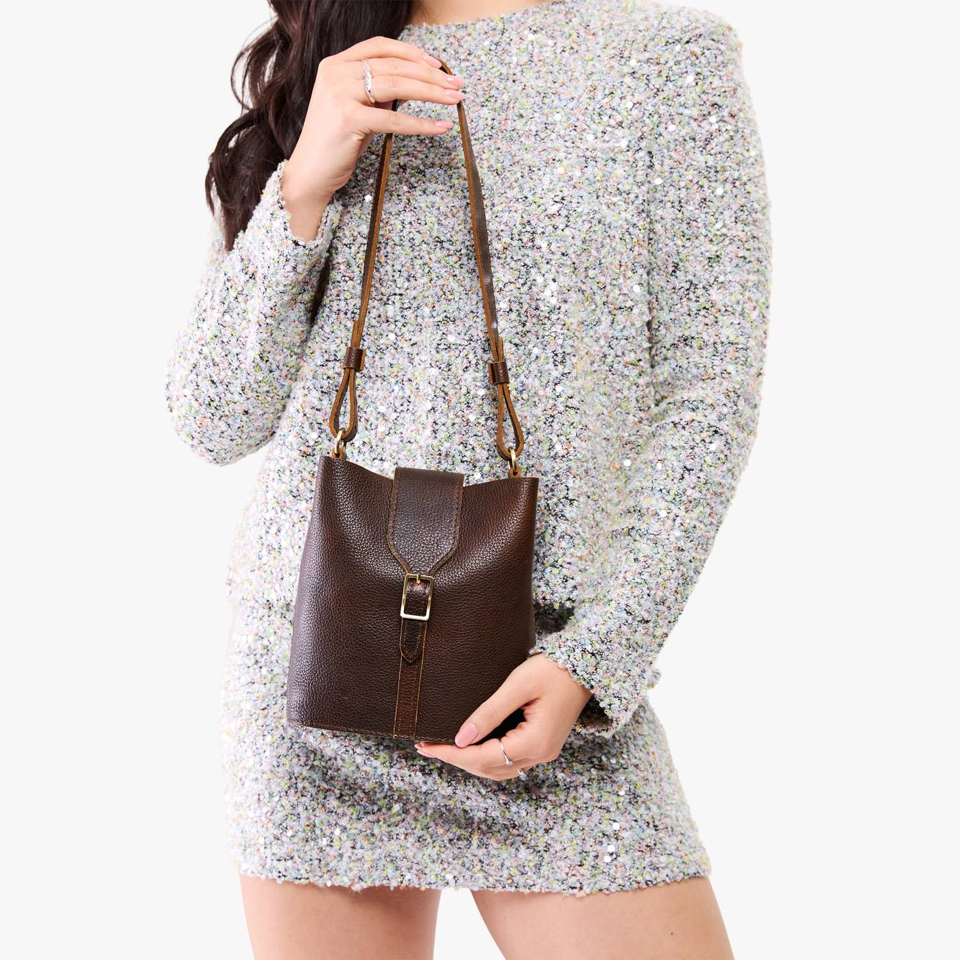 Coldbrew | Model wearing leather bucket shoulder bag with adjustable strap and magnetic closure 