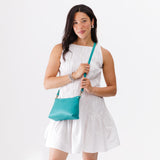 Seafoam Classic | Model holding a zip top crossbody bag with detachable strap