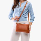 Sienna Classic | Model holding a zip top crossbody bag with detachable strap