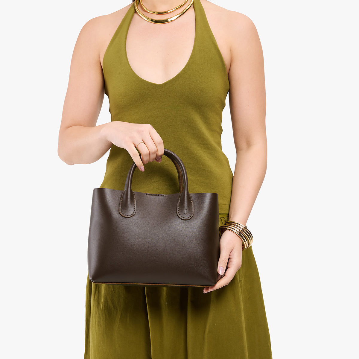 Grizzly*Large | Model holding mid-size tote purse with  structured leather handles and crossbody strap