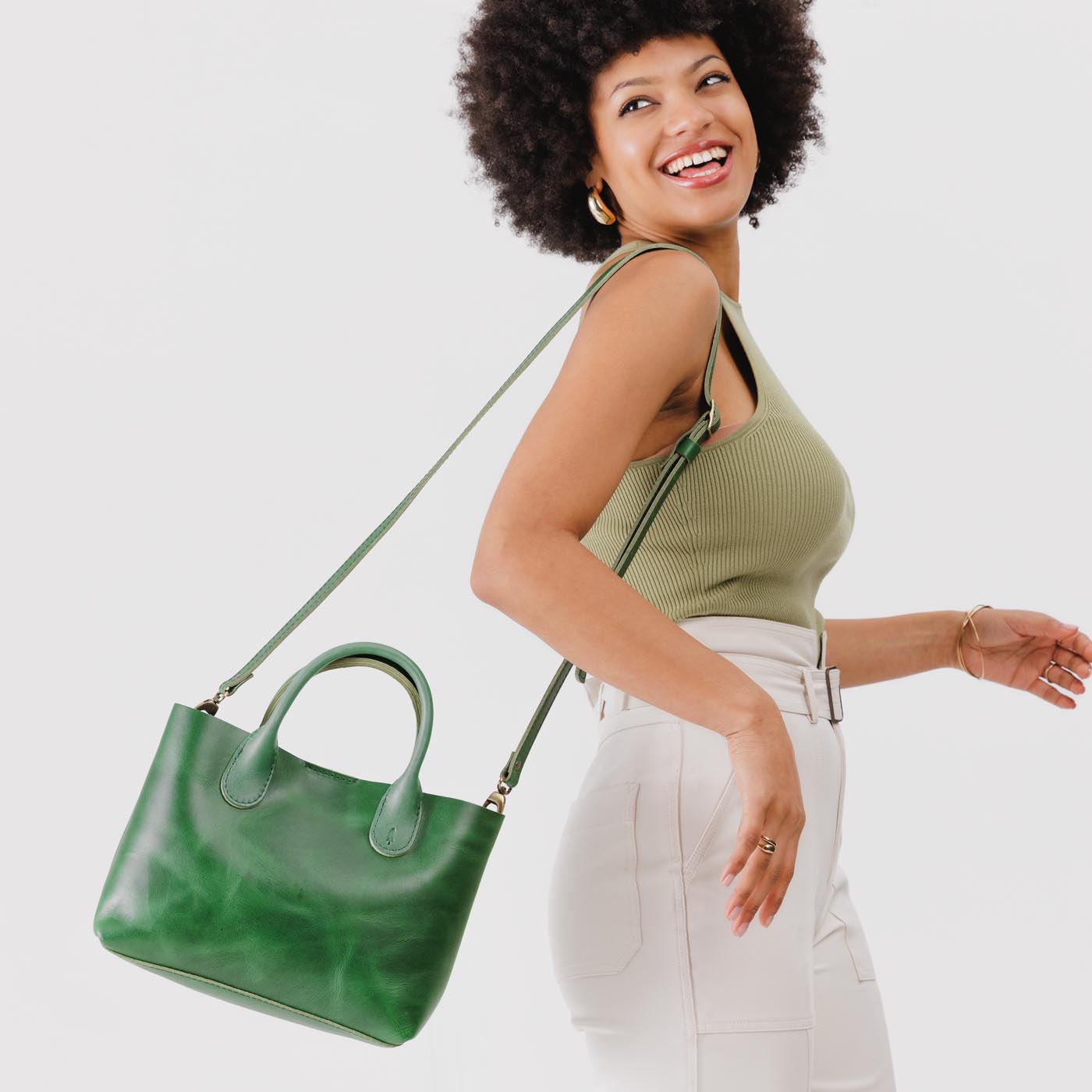 Cowboy Mint*Large | Model holding mid-size tote purse with  structured leather handles and crossbody strap