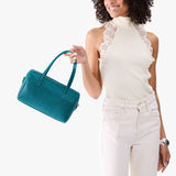 Aquarius Large | Model holding mini duffle shaped handbag with crossbody strap