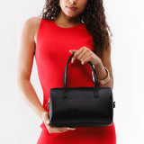 Black Large | Model wearing mini duffle shaped handbag with crossbody strap