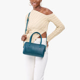 Westward Blue Large | Model holding mini duffle shaped handbag with crossbody strap