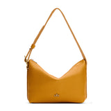Sunshine Small | Slouchy Shoulder Bag that has a zipper opening and three metal tree emblems on a white background