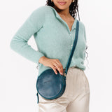 Lagoon Small | Model wearing circle shaped crossbody bag with top zipper