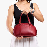 Chili Red Small | Model holding a half circle crossbody bag with handles and removable crossbody strap 