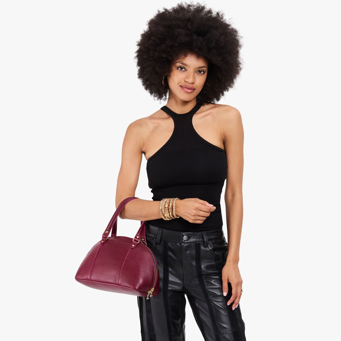 Orchid*Small | Model holding a half circle crossbody bag with handles and removable crossbody strap 
