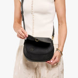 Full Moon Small | Model wearing a leather Crossbody with a flap and magnetic closure