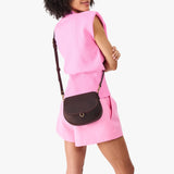 Moose Small | Model wearing a petite leather Crossbody with a flap and magnetic closure