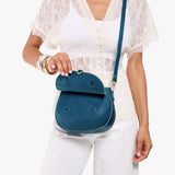 Planetary Small | Model wearing a leather Crossbody with a flap and magnetic closure