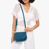 Planetary Small | Model wearing a leather Crossbody with a flap and magnetic closure