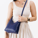 Cobalt Small | Model wearing petite shoulder bag with adjustable strap and magnetic snap closure