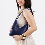 Cobalt Small | Model wearing petite shoulder bag with adjustable strap and magnetic snap closure