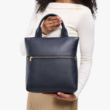 Night Owl Small | Model wearing a convertible tote clutch crossbody