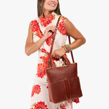Nutmeg Small | Model wearing a convertible tote clutch crossbody