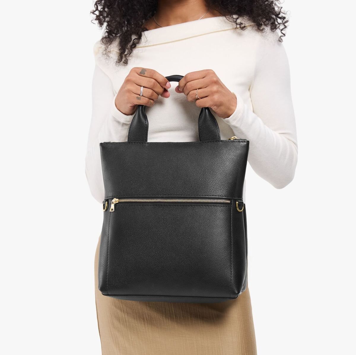Pebbled--black*Small | Model wearing a convertible tote clutch crossbody