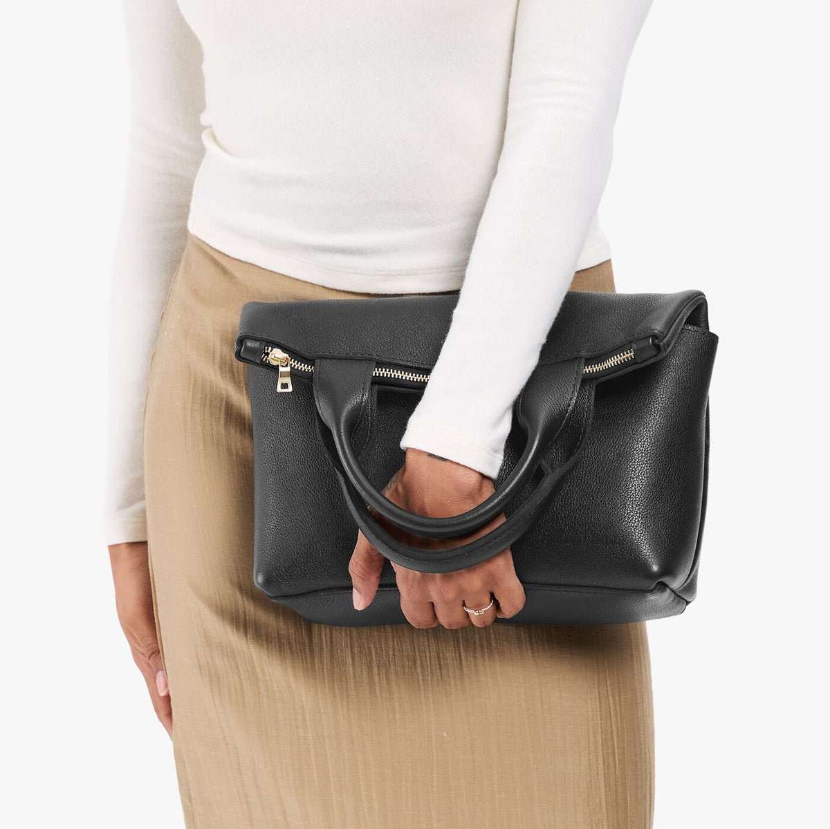 Pebbled--black*Small | Model wearing a convertible tote clutch crossbody