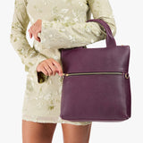 Plum Small | Model wearing a convertible tote clutch crossbody