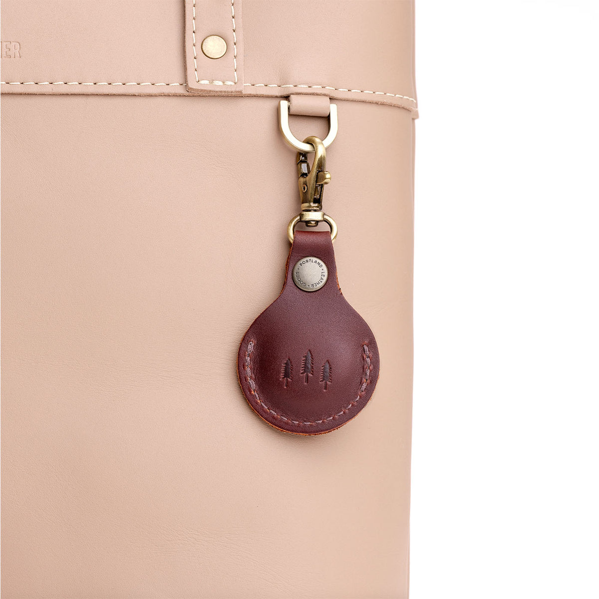 Cognac | Round leather AirTag holder with snap closure and swivel lobster claw clasp