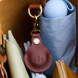 Cognac | Round leather AirTag holder with snap closure and swivel lobster claw clasp