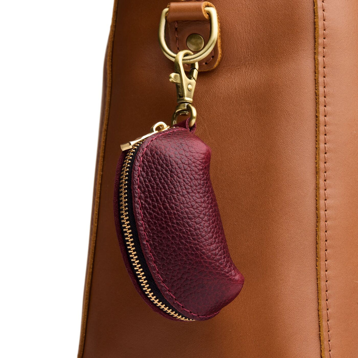 Cabernet | Taco shaped leather pouch with zipper and swivel lobster clasp on white background