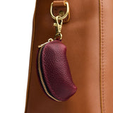 Cabernet | Taco shaped leather pouch with zipper and swivel lobster clasp on white background